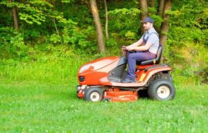 Husqvarna lawn mower cutting grass in a well-maintained garden with precision and efficiency