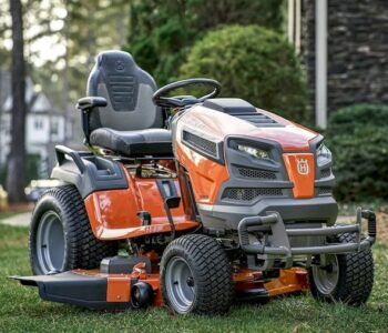 Husqvarna lawn mower cutting grass in a well-maintained garden with precision and efficiency